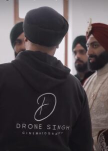 A group of men in turbans having a conversation indoors.