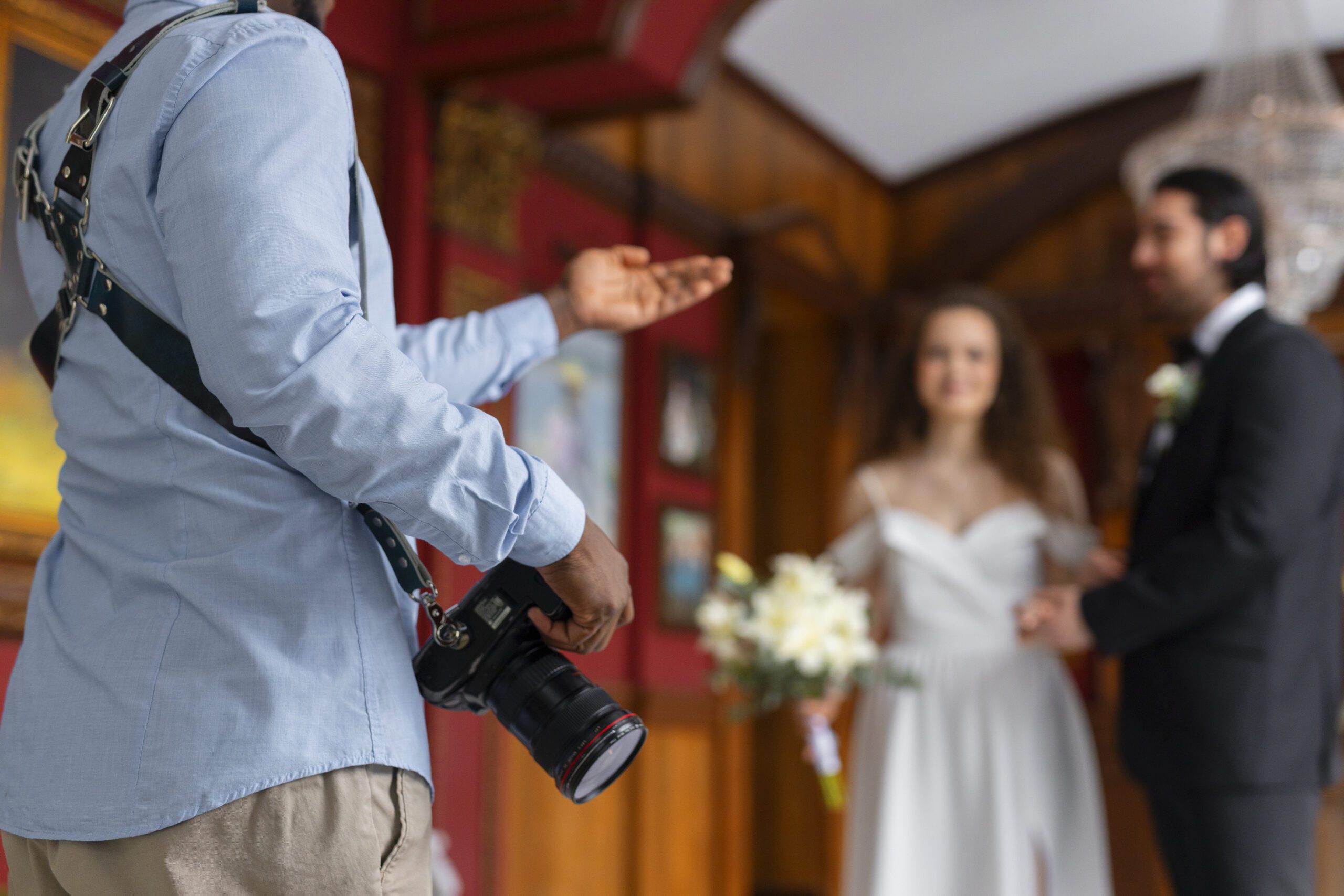 Photographer directing couple during wedding shoot.